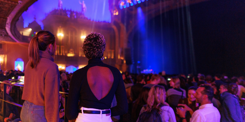 Two women watching a band at The Forum during the Rising Festival.