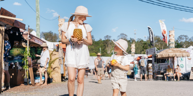 A mother and child walking through Woodford Folk Festival.