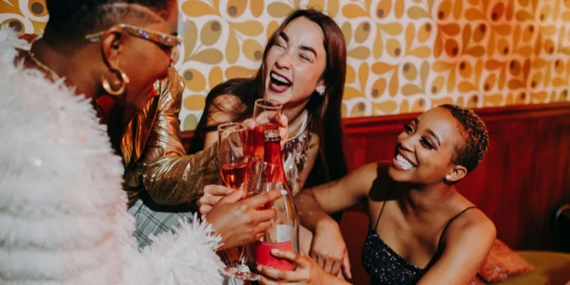 Friends enjoying drinks at a busy Fortitude Valley bar at night
