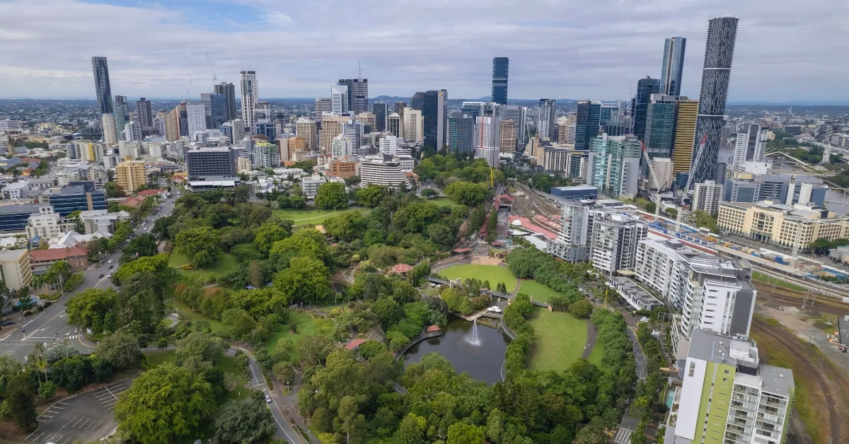 Aerial view of Roma Street Parkland with pond and Brisbane skyline.