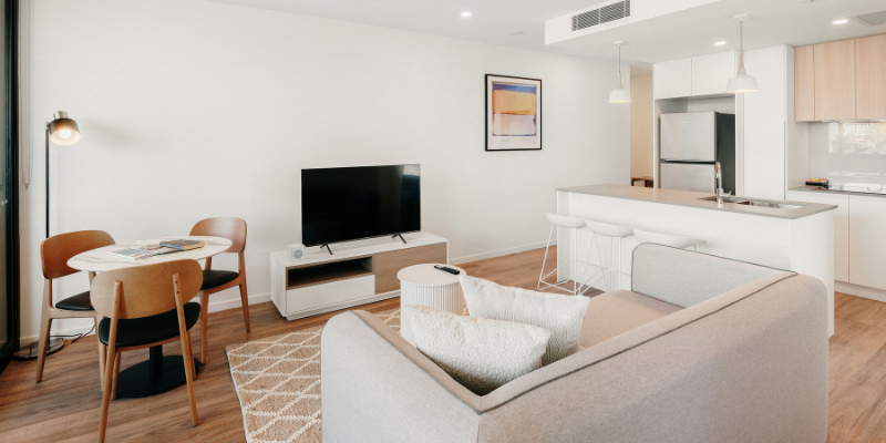 Modern apartment interior with living room, dining area, and kitchen at Perry House