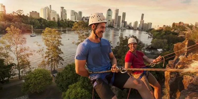 Travellers enjoying abseiling at Kangaroo Point cliffs overlooking the Brisbane River