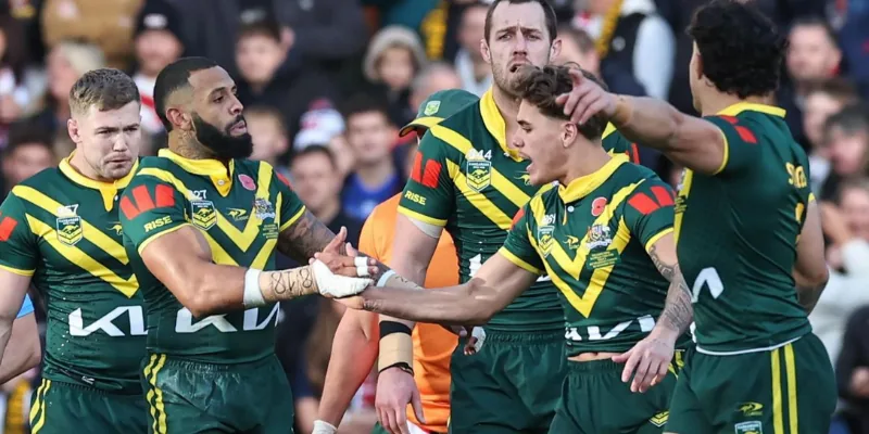 Australian Rugby players in green and gold celebrate a play during a game