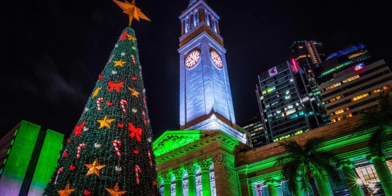 Brisbane City Hall and a Christmas tree illuminated at night.