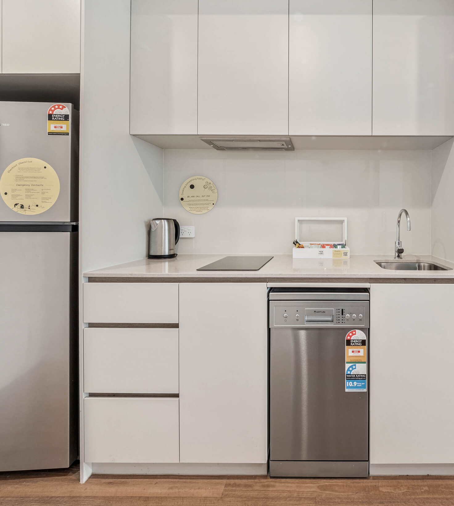 Kitchenette with cooktop, dishwasher, kettle and fridge in a Deluxe Studio Apartment at Rambla @ Story House