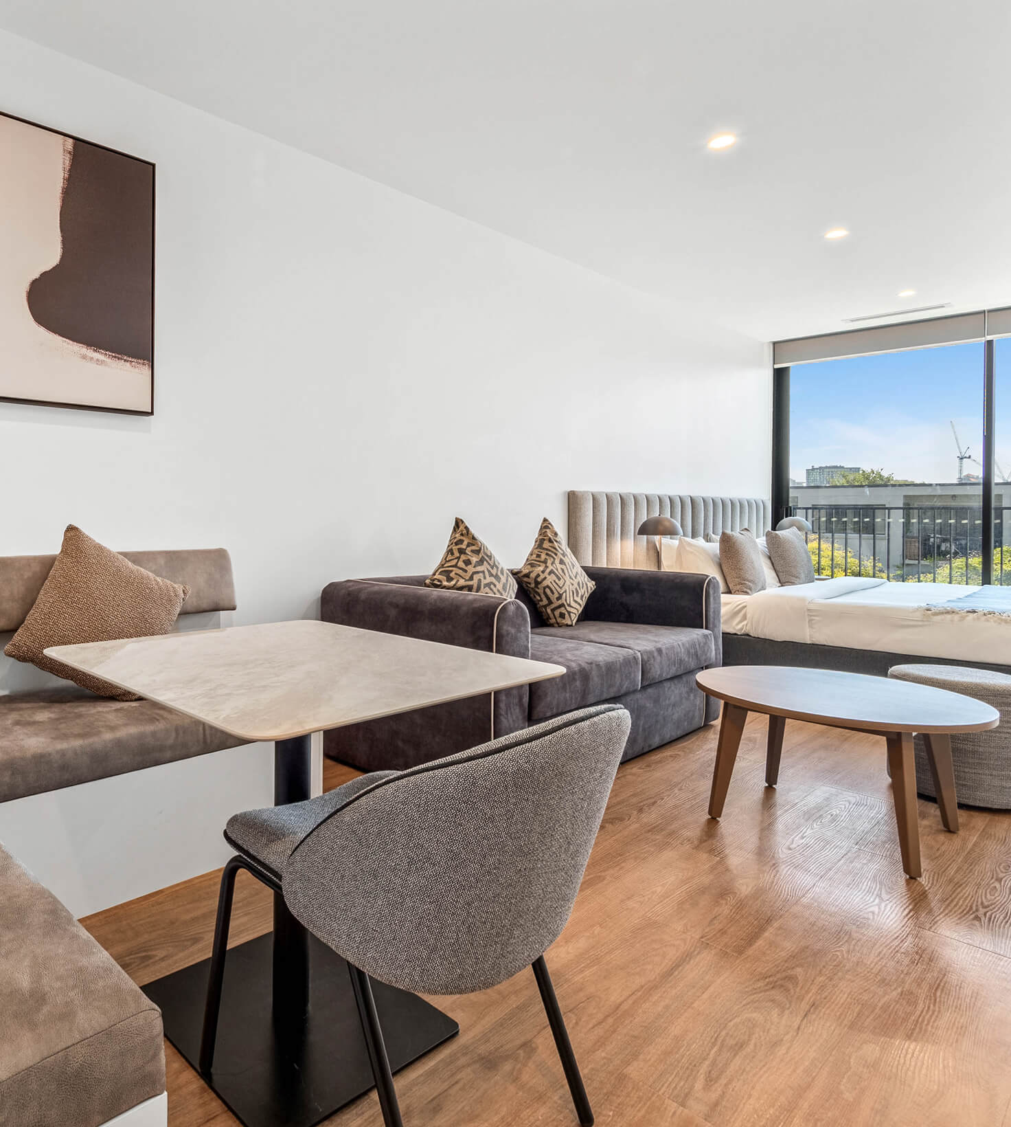 Dining banquette and lounge looking out to the balcony in a Deluxe Studio Apartment at Rambla @ Story House