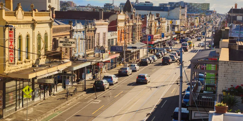 Sydney Road Brunswick lined with shops, cafes and tram tracks in Melbourne's inner north