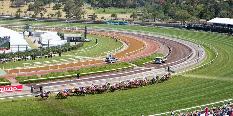 Field of racehorses rounding the bend during the Melbourne Cup Carnival