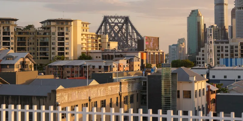 Story Bridge rising behind Fortitude Valley rooftops near Rambla's Berwick House.