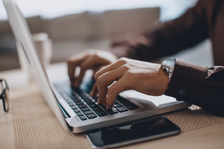 Person typing on a laptop keyboard