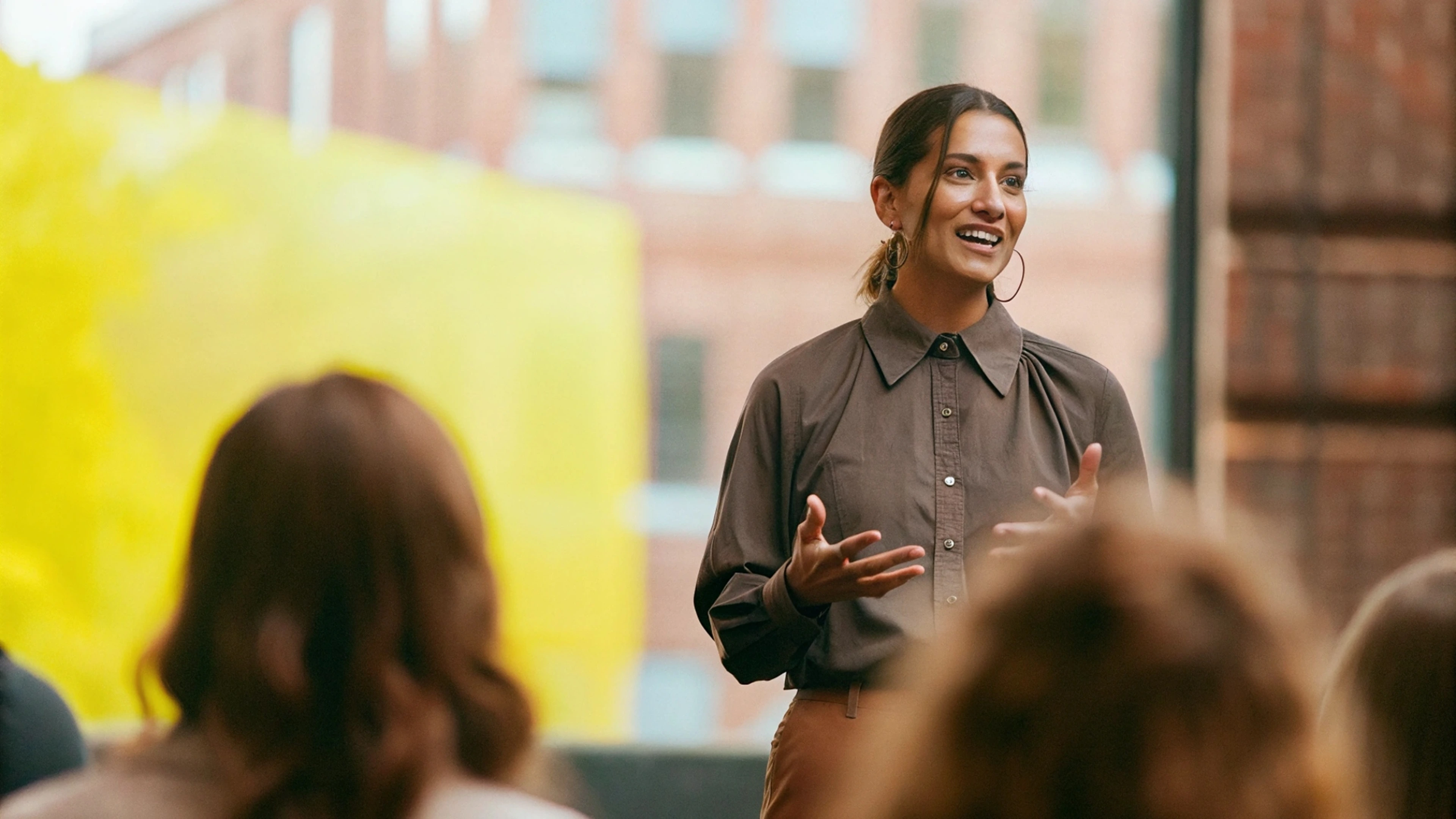  Person speaking confidently to a crowd, illustrating the answer to “Why is vocabulary important?”