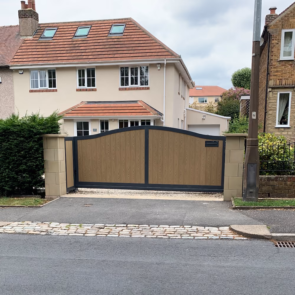 A newly installed residential sliding gate made out of composite wood.