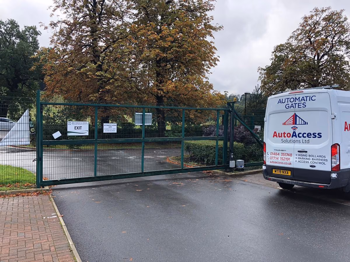 A photo of Auto Access Solutions branded van next to a newly installed commercial gate.