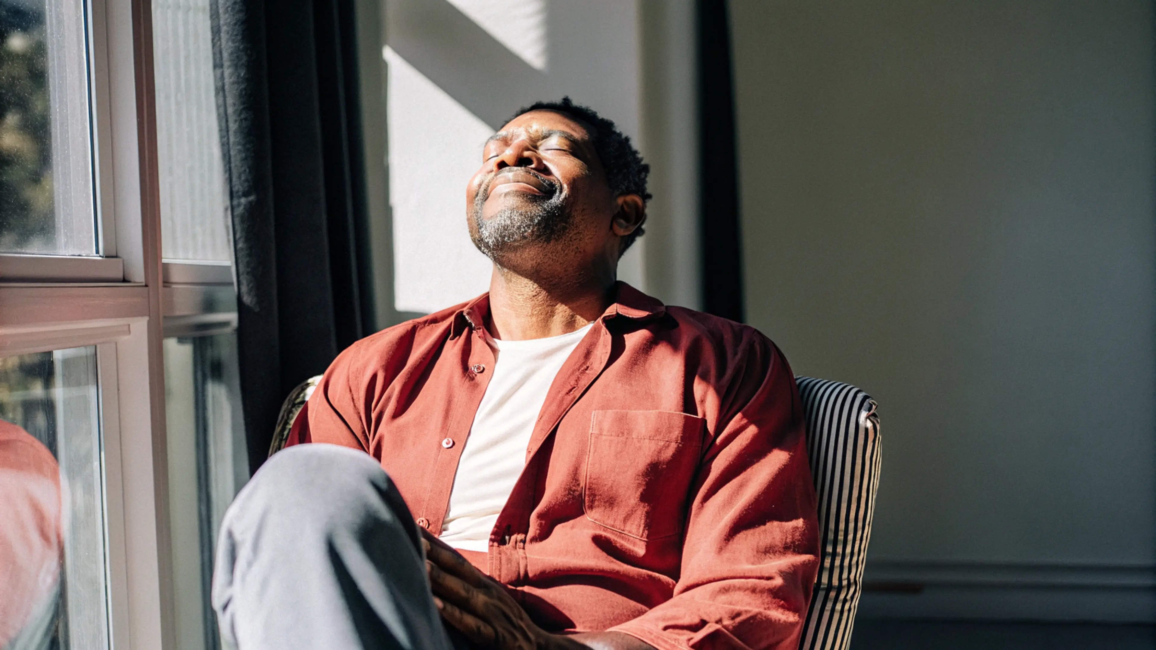 A person with their eyes closed practicing NSDR, non-sleep deep rest.