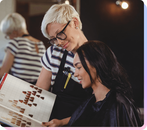 Beauty professional in a salon using SalonInteractive to grow their business