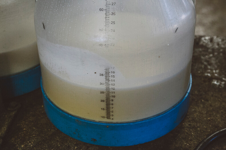 Measuring flask with separated white and yellow liquid layers