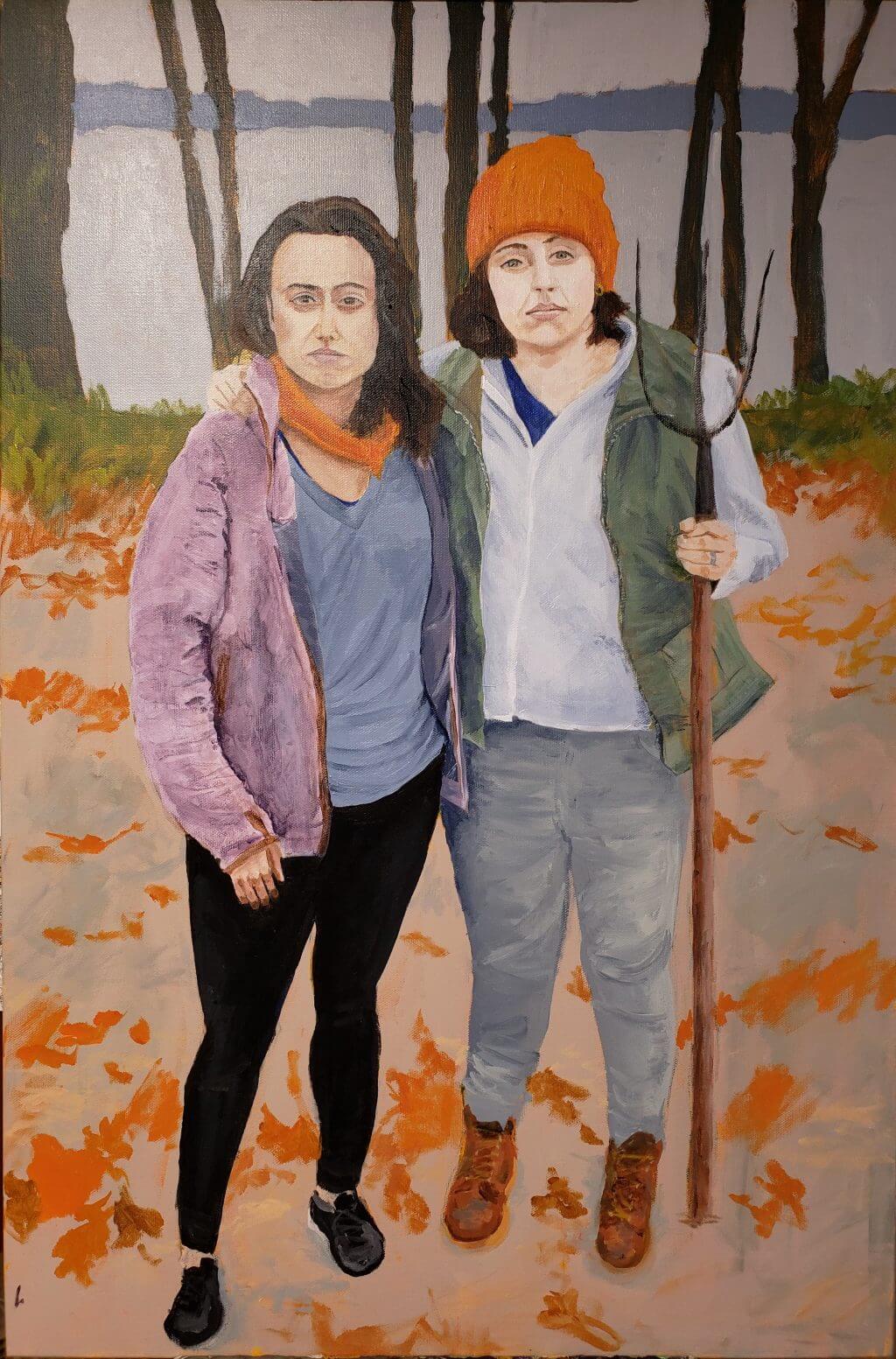 Two people standing together in autumn forest with fallen orange leaves
