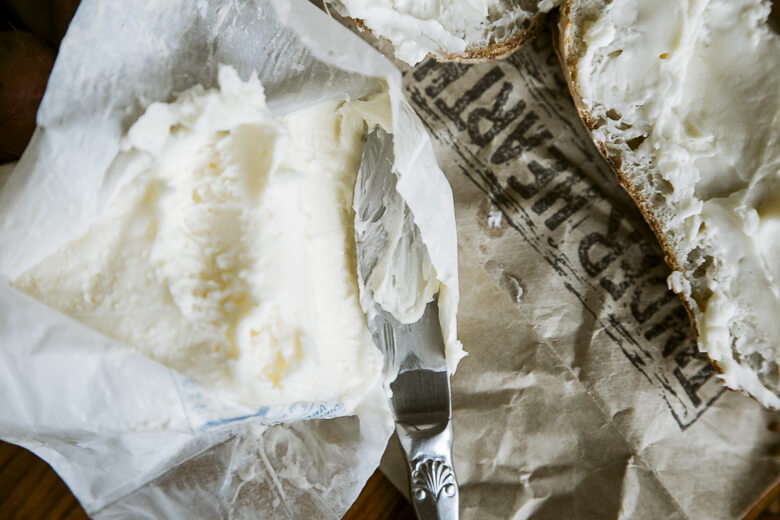 Cream cheese spread on bread with vintage silver knife