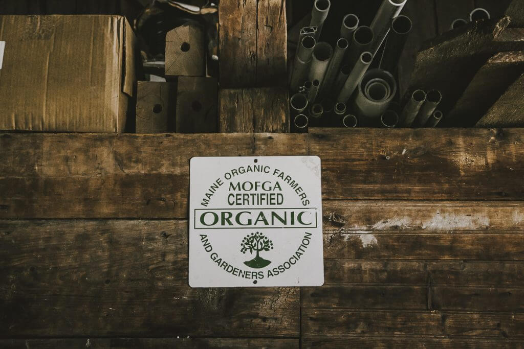 Maine organic farmers certification sign on rustic wooden background