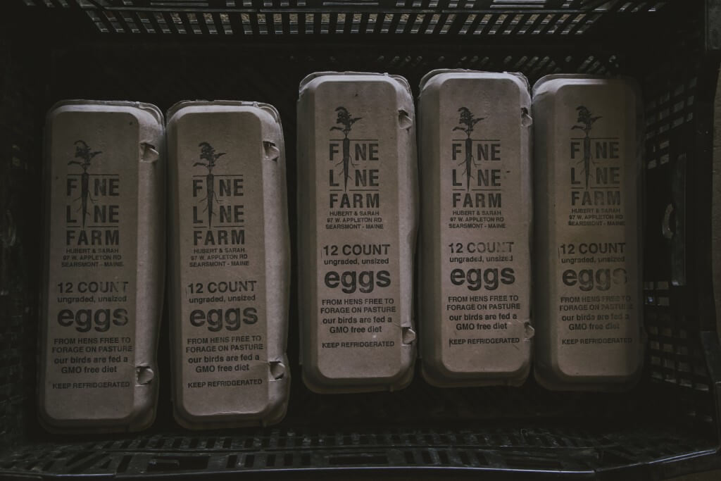 Fine Line Farm egg cartons on shelf, showcasing 12-count GMO-free eggs