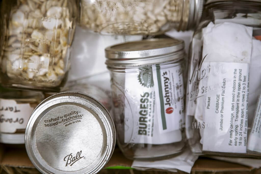 Glass mason jars filled with dry goods and various labels