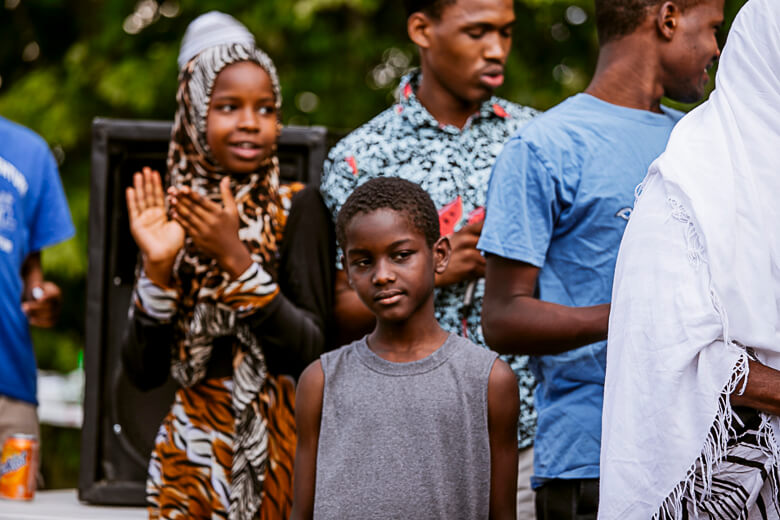 Group of children standing together outdoors, wearing colorful clothing