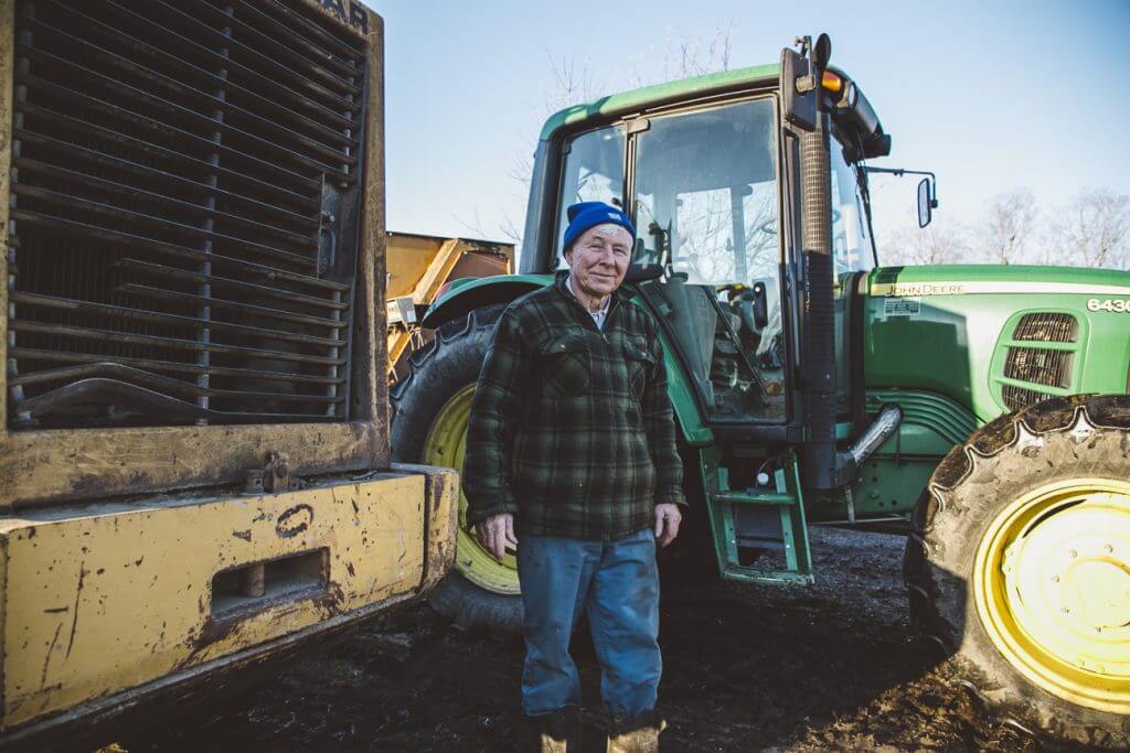 A man standing in front of a tractor