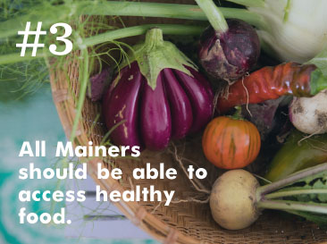 Fresh vegetables including eggplants, onions, and tomatoes in a basket