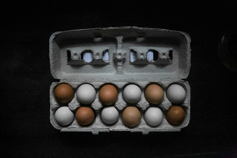 Carton of brown and white eggs arranged in organized rows