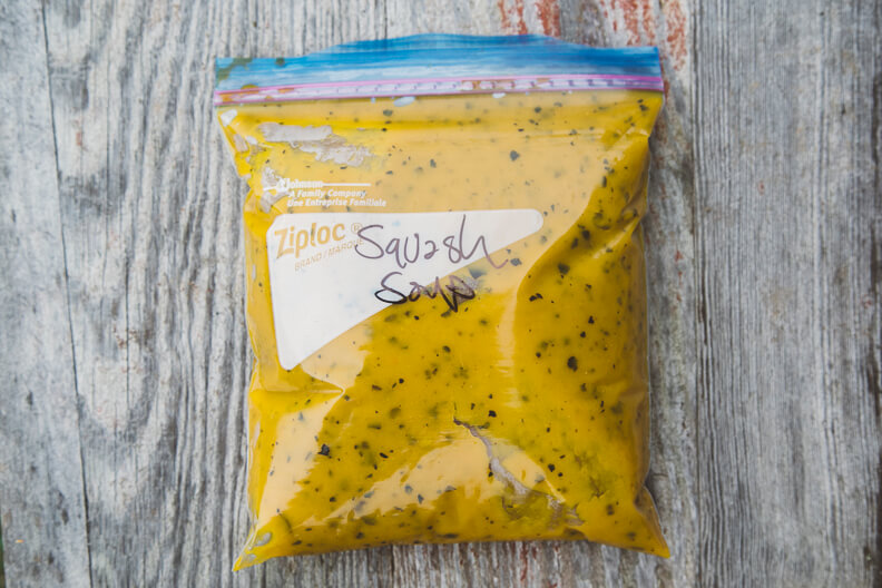 Yellow Ziploc bag with speckled sauce or marinade on wooden background
