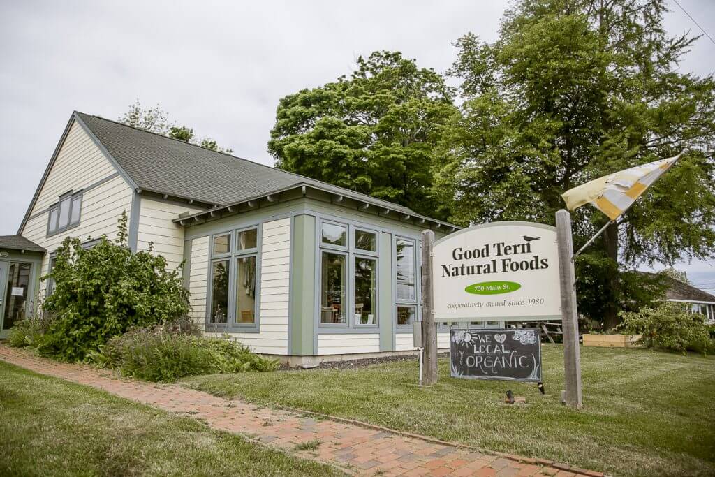 Good Tern Natural Foods storefront with organic sign and trees