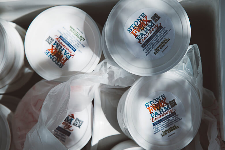 Stone Brew Farm creamery containers stacked with product labels visible