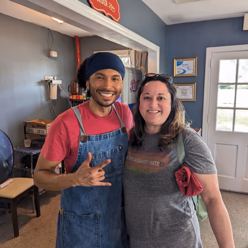 Chef Leon with a customer inside Leon's at Lake Ella Restaurant - Varona Designs