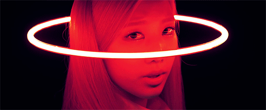 Animated glitch art of a person lit in red with a glowing neon ring circling their head