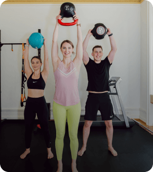 fitness trainer guiding two people during an energizing workout session