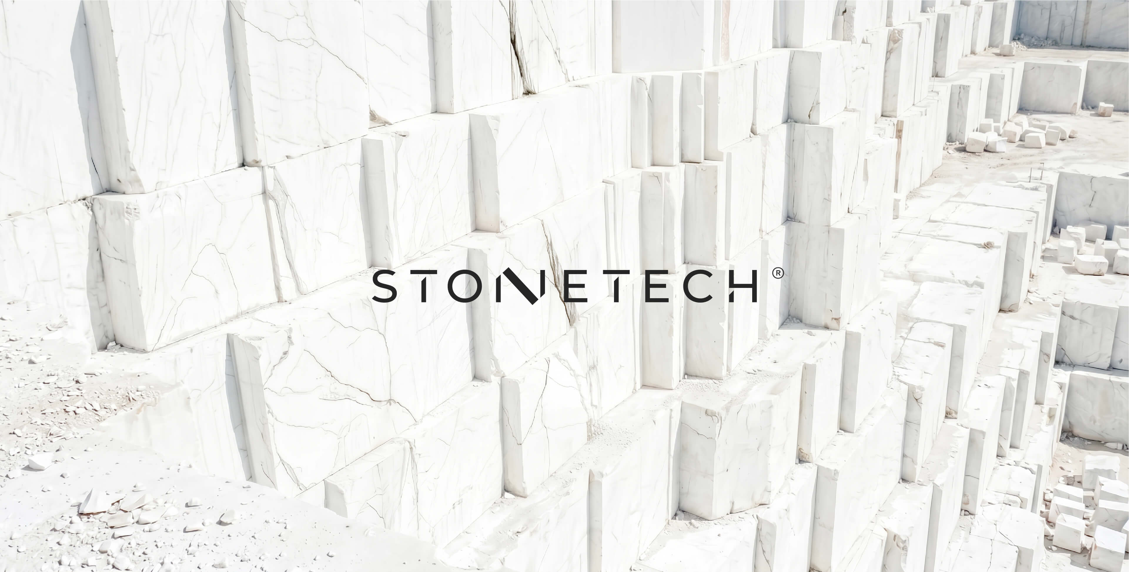 Stacked white marble blocks with subtle gray veining and the Stonetech logo centered — Stonetech by Lazy snail Design