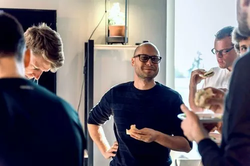 People socialise over pleasant chat and food in the common area.