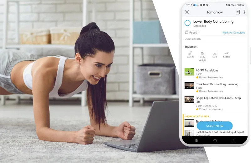 Woman doing a plank exercise while looking at laptop.