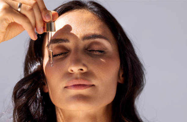 Woman applying peptide serum as part of a daily routine to hydrate and smooth the skin.