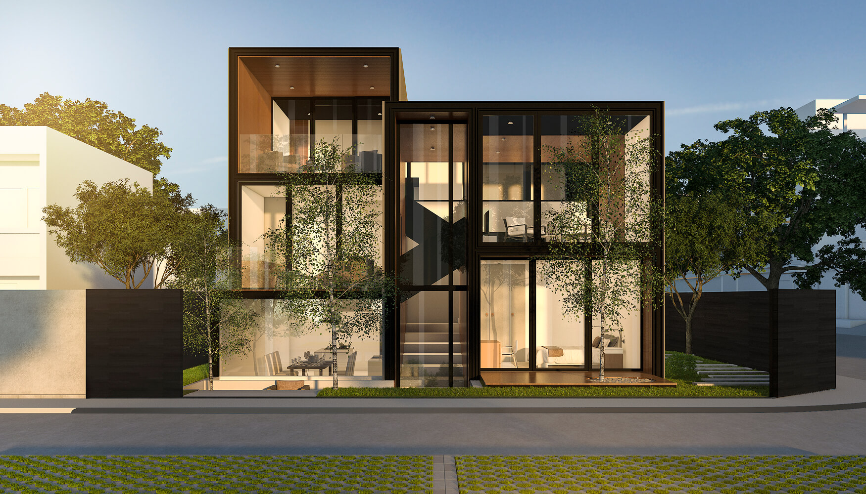 Modern two-story house with large glass windows, surrounded by trees and fenced yard at sunset.