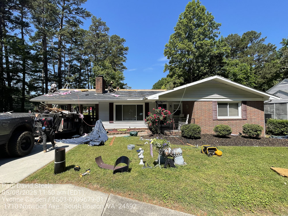 A roof with Onyx Black shingles getting installed.
