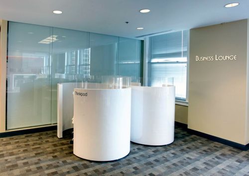 A white round object is placed in a modern business lounge with stylish interior design.