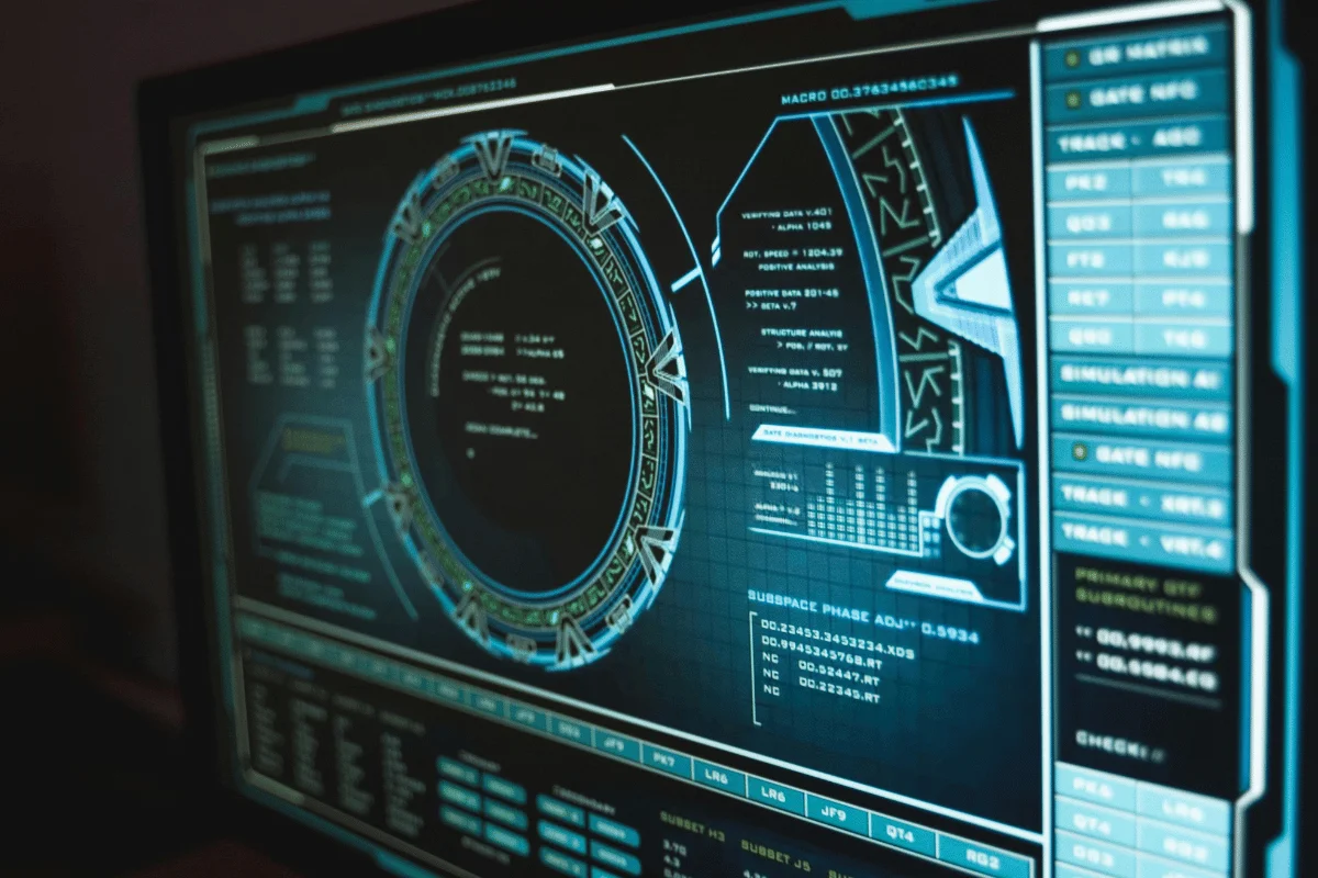 Futuristic computer screen displaying complex circular interfaces and data charts, conveying a high-tech, sci-fi atmosphere with blue tones.