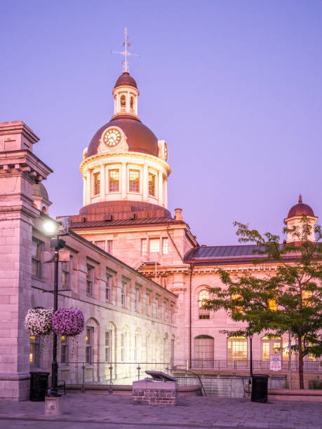 Historic Kingston City Hall in downtown Kingston, Ontario, featuring its iconic domed clock tower at sunset.