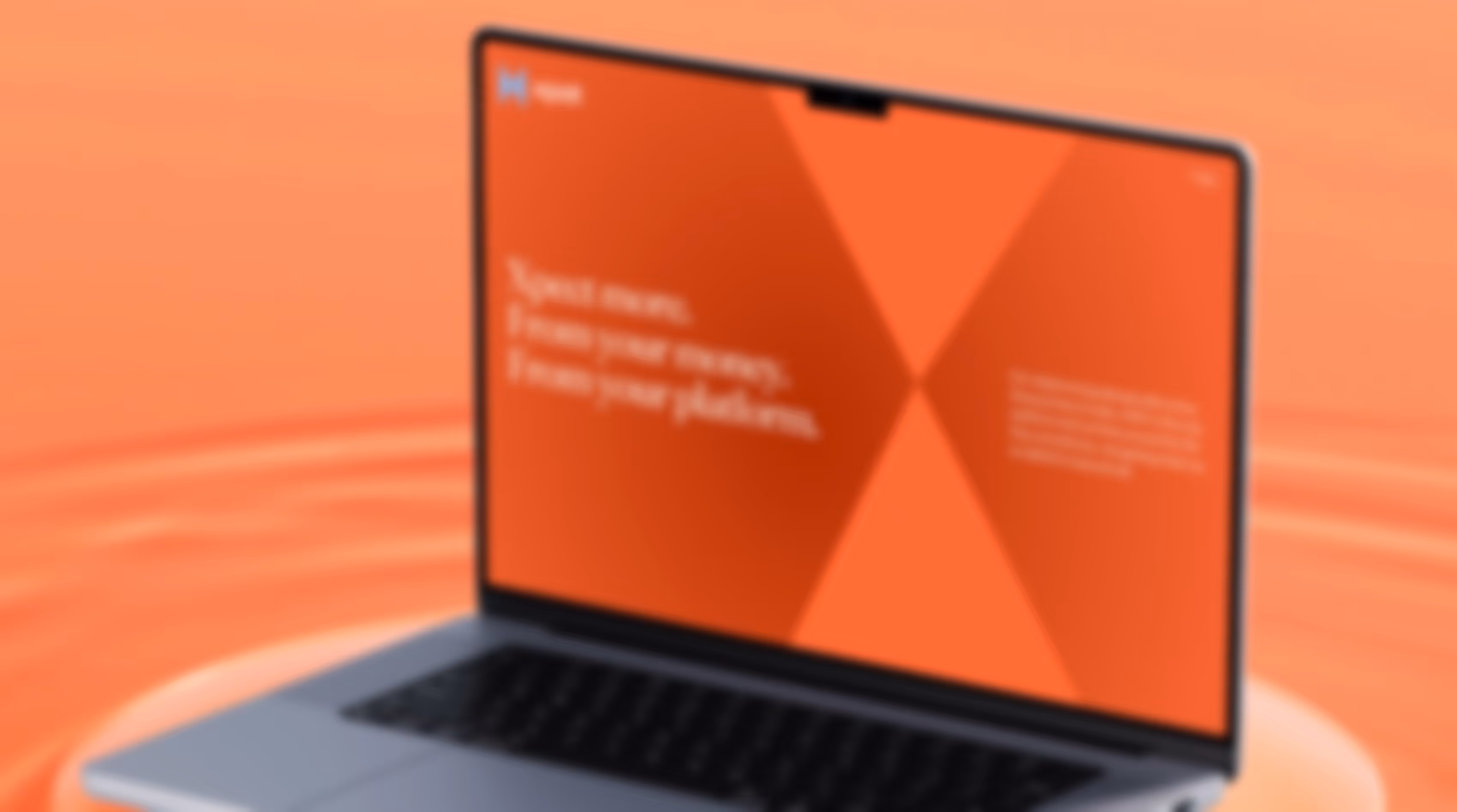 Laptop displaying a red-orange screen with geometric design and partially visible motivational text about speed, energy, and platform.