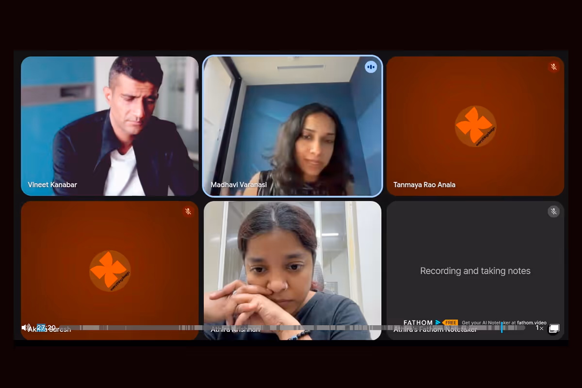 Video call screen with six participants, including Vineet Kanabar and Madhavi Varanasi visible, and others muted or using avatars, one participant appears thoughtful.