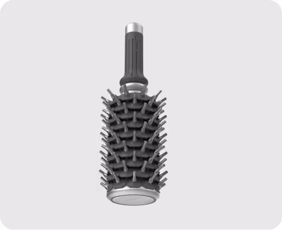 Black cylindrical hairbrush with wide handle and rubber bristles on a gray background.