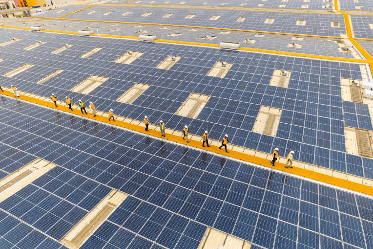Energy experts inspecting a large-scale solar plant