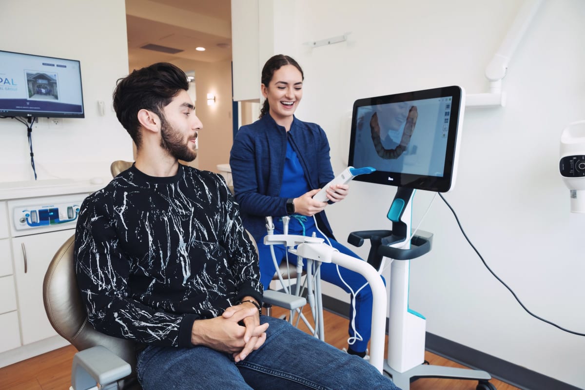 Invisalign patient smiling after eating allowed foods during orthodontic treatment