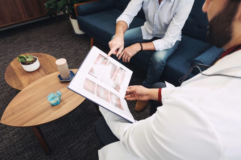 Dental implant patient consultation at Opal Dental Group in Dupont showing dentist explaining procedure to patient.